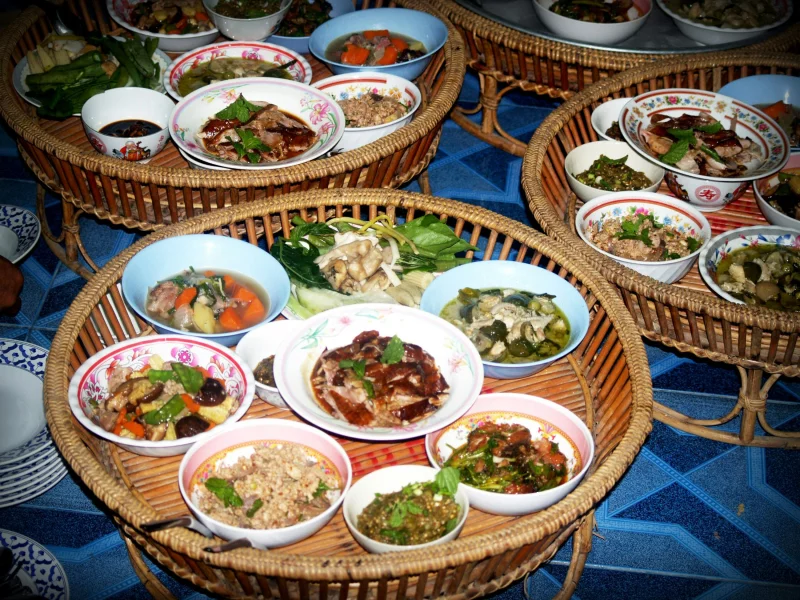 Colorful Asian dishes served on traditional bamboo trays, showcasing a variety of delicious meals.