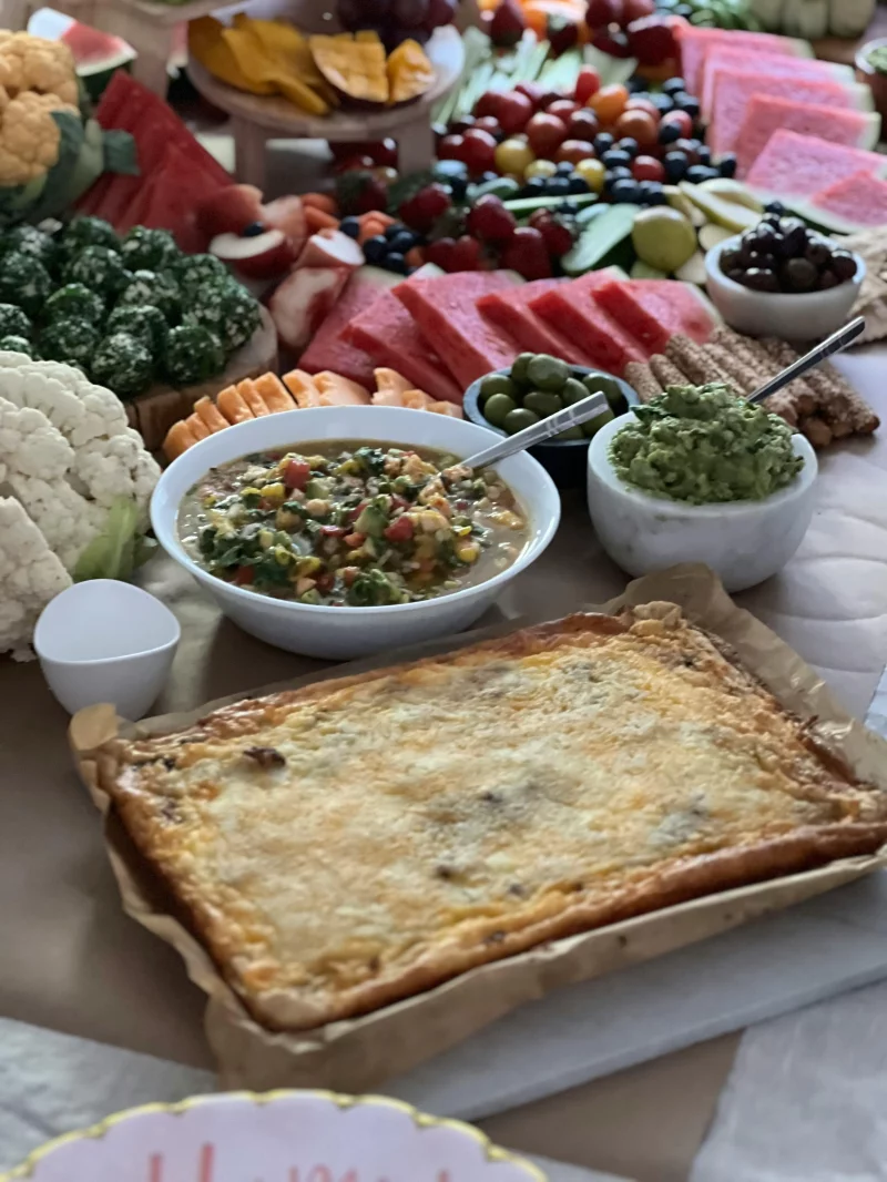 A vibrant fruit and vegetable platter with assorted dips, perfect for entertaining.