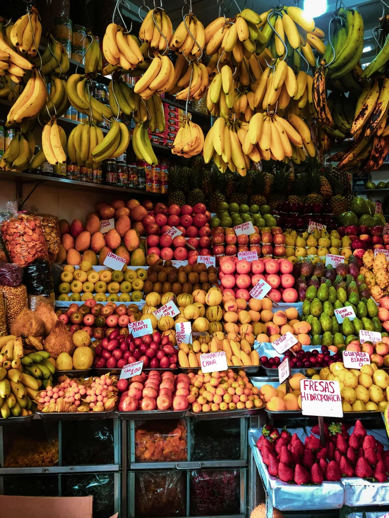 Vibrant array of fresh fruits artistically displayed at a bustling market stall, highlighting a diverse selection of healthy options.