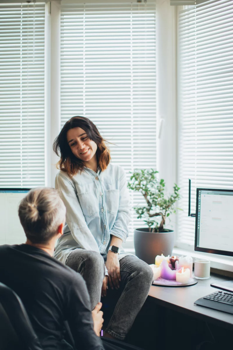 A couple enjoying a relaxed moment in their cozy home office, surrounded by warm ambiance.