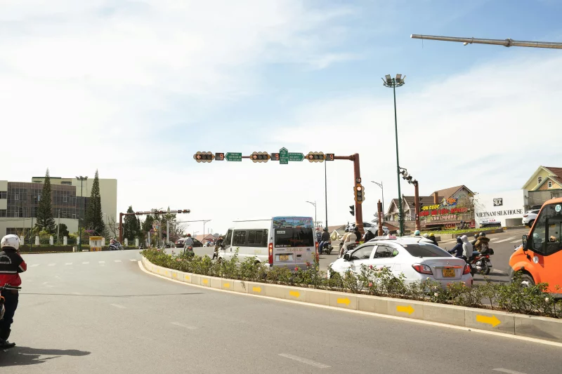 Traffic at a busy intersection in Vietnam, showcasing urban life and transportation.