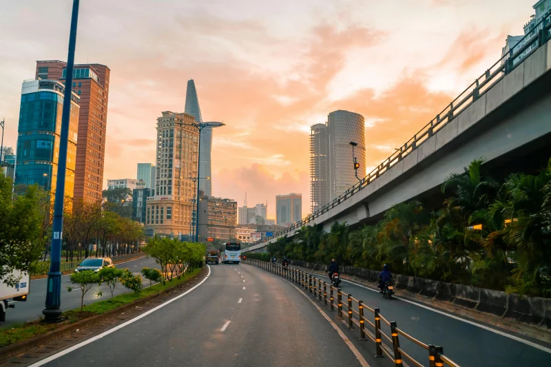 Explore the dynamic architecture and vibrant streets of Ho Chi Minh City at sunset, captured with lively urban vibes.