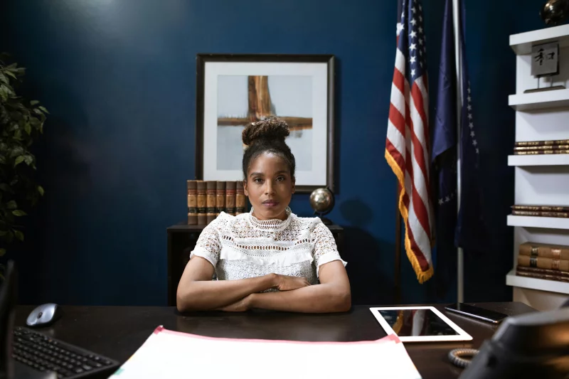 A confident woman in a professional office setting, embodying leadership and expertise.