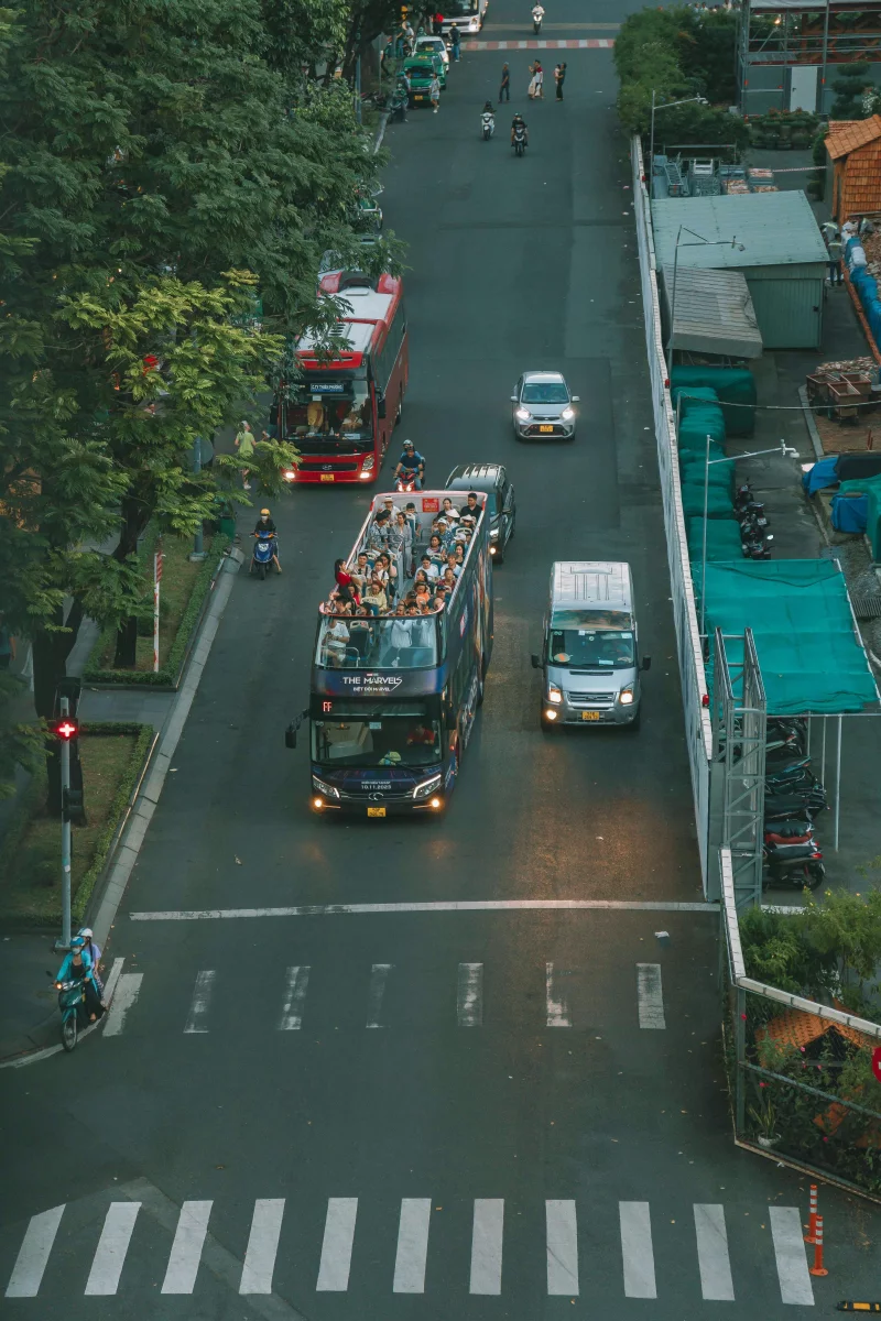 A vibrant aerial view of traffic in Ho Chi Minh City with buses and cars.