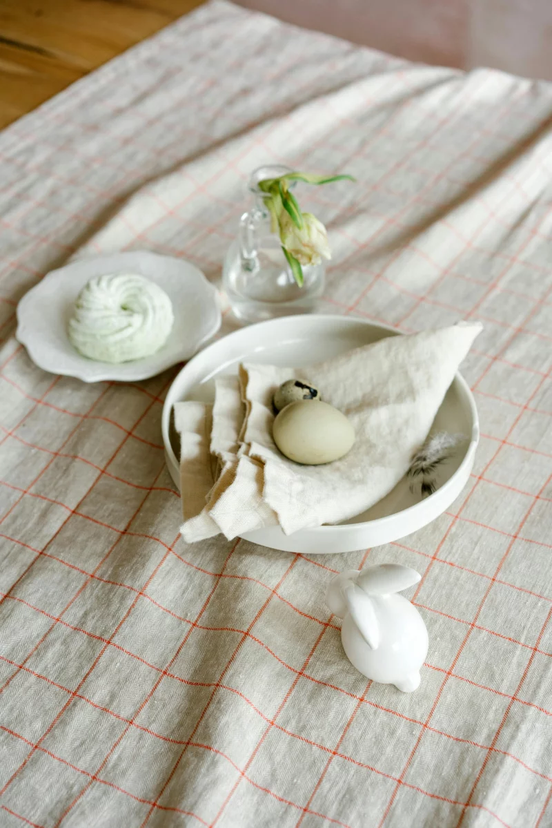 Festive Easter table with egg and ceramic bunny for a cozy celebration.