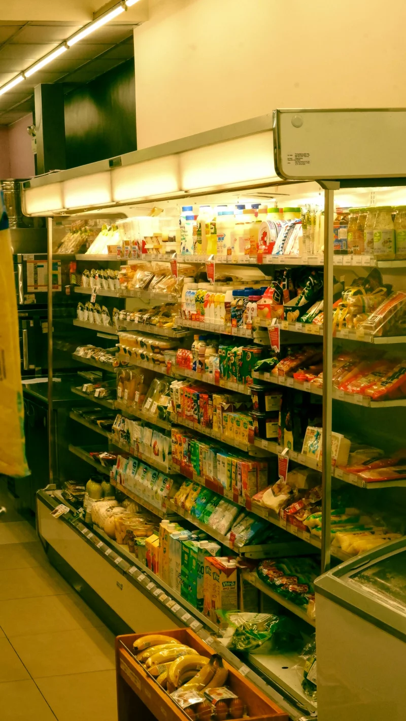 Wide variety of grocery items displayed on shelves in a supermarket in Ho Chi Minh City, Vietnam.
