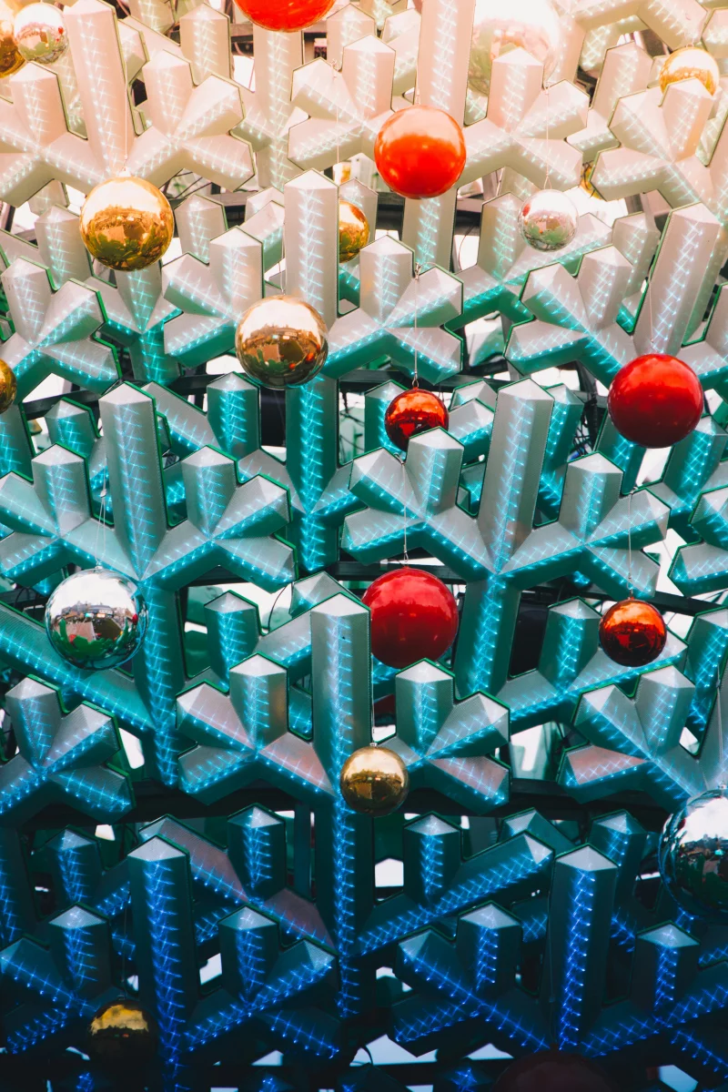 Creative display of abstract Christmas decorations with colorful ornaments and a bright festive feel.