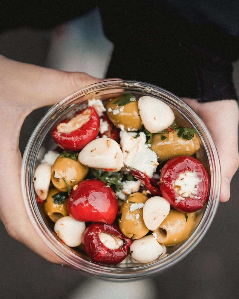 Enjoy a delicious Mediterranean salad bowl with olives, cheese, and peppers for a healthy meal.