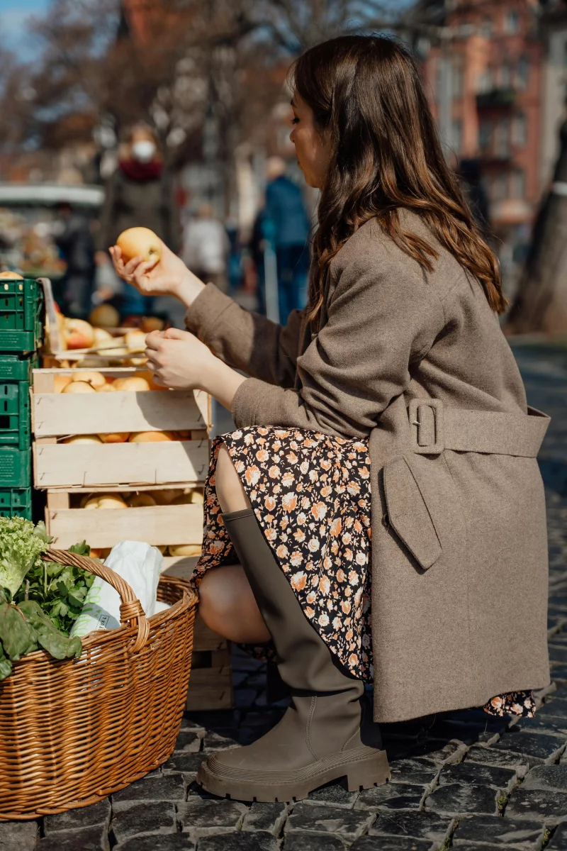 A woman shops for fresh apples at an outdoor market in Erfurt, Germany.