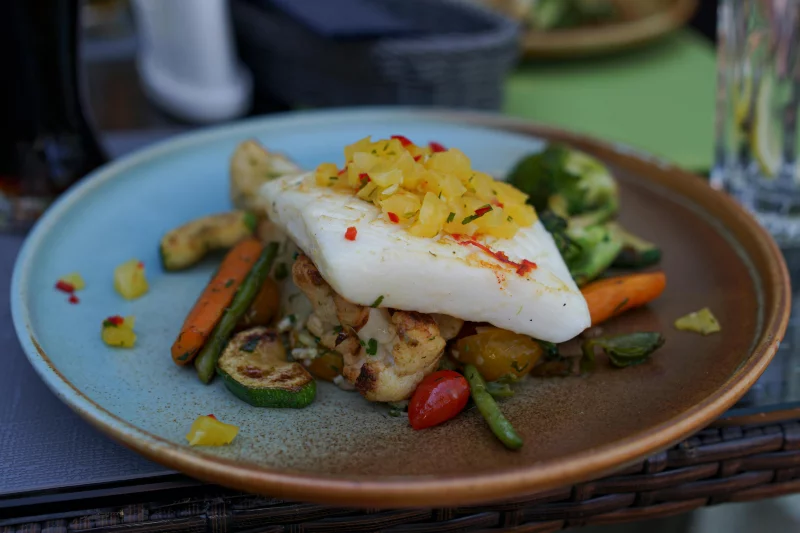 A mouth-watering plate of grilled fish served with fresh vegetables from a Gdynia restaurant.