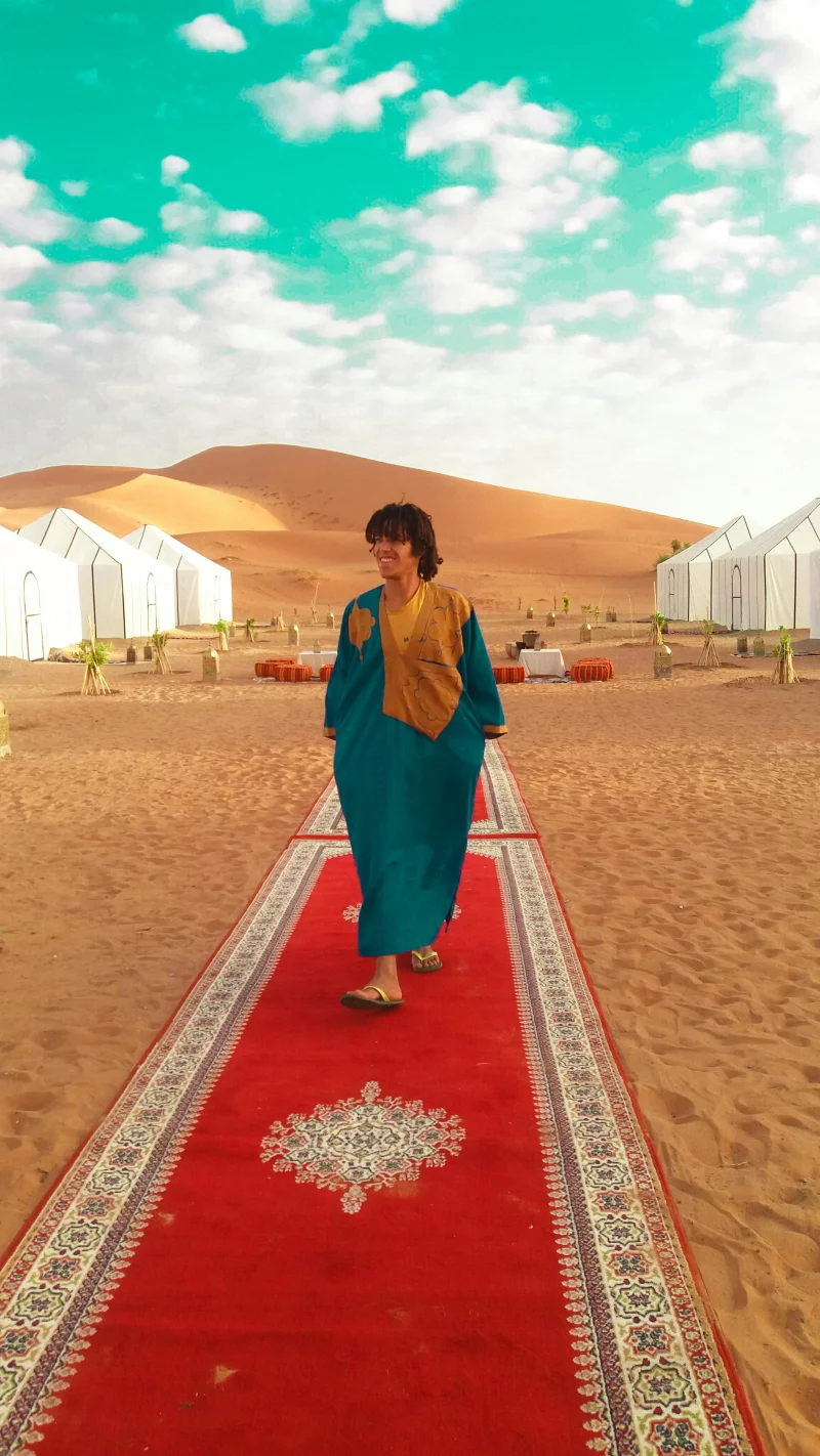 Experience a serene luxury camp in Morocco's Merzouga desert with Berber cultural elements.