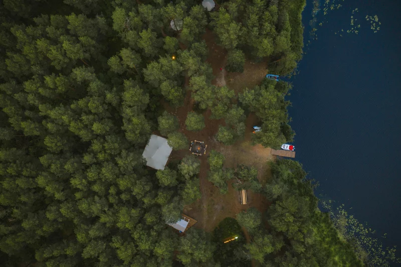 Aerial view of a forest campsite by a serene lake in Tver Oblast, Russia.