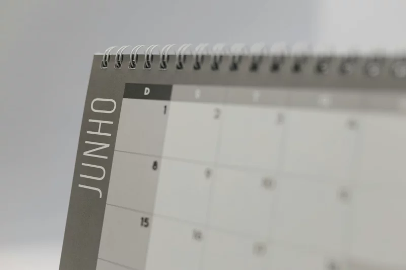 A detailed shot of a June calendar page with spiral binding, featuring Portuguese text.