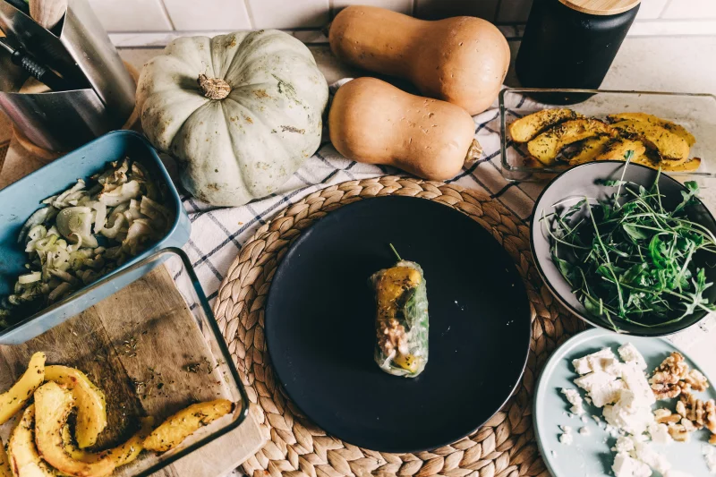 Flat lay of a healthy vegan meal with pumpkin and arugula in an Erfurt kitchen setting.
