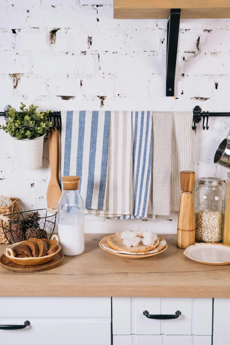 A modern kitchen countertop with breakfast items including milk, pastries, and utensils.