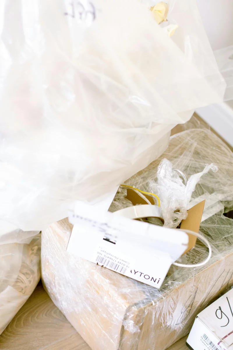 Plastic-wrapped boxes and supplies for moving or renovation in a home setting.