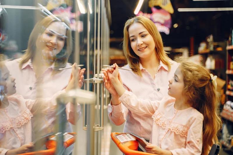 Woman and girl enjoying a shopping experience together at a supermarket.