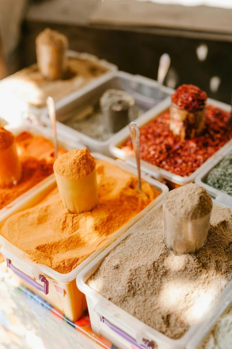 Vibrant assortment of spices at an outdoor market in Georgia, showcasing flavor diversity.