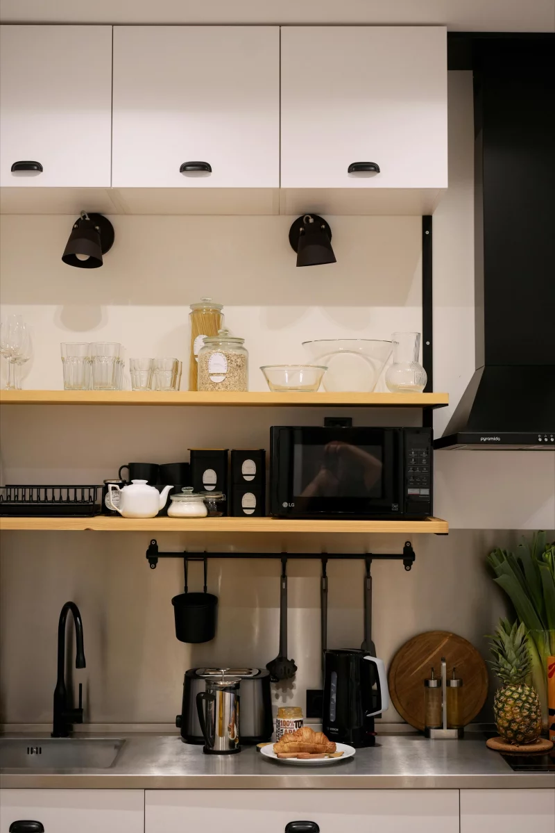 Cozy kitchen with modern appliances and open shelving, perfect for home chefs.