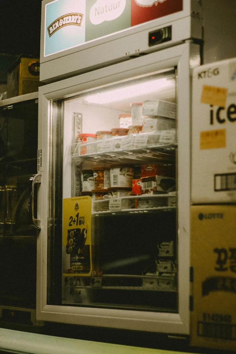 Stock photo of Ben & Jerry's ice cream freezer in a store aisle.