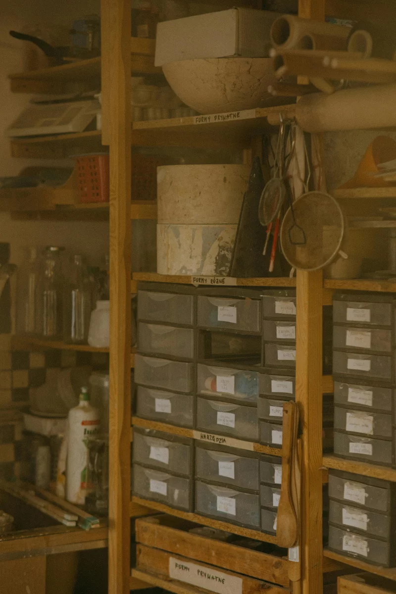 A neatly arranged storage room with labeled boxes and wooden shelves.