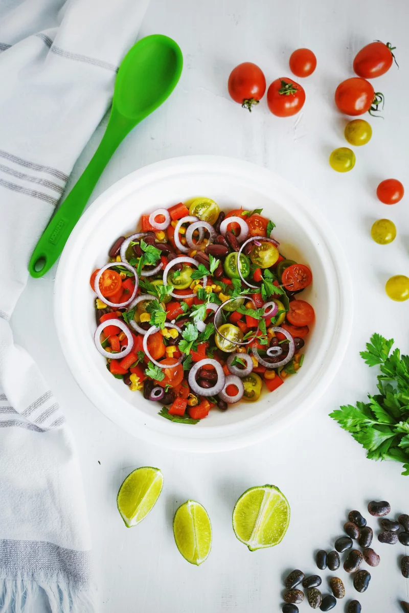 A vibrant salad with tomatoes, onions, and herbs, perfect for a fresh meal.