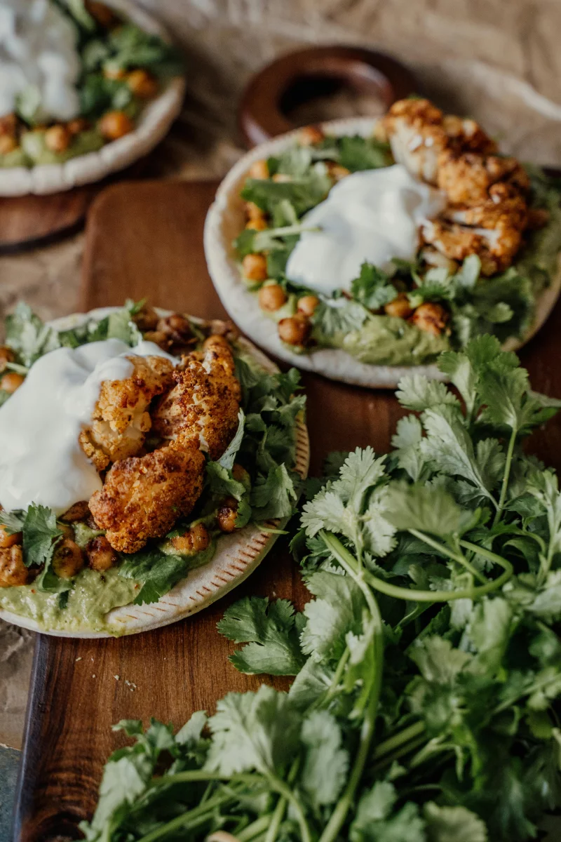 Delicious roasted cauliflower wraps with chickpeas and fresh greens, perfect for a healthy vegan meal.