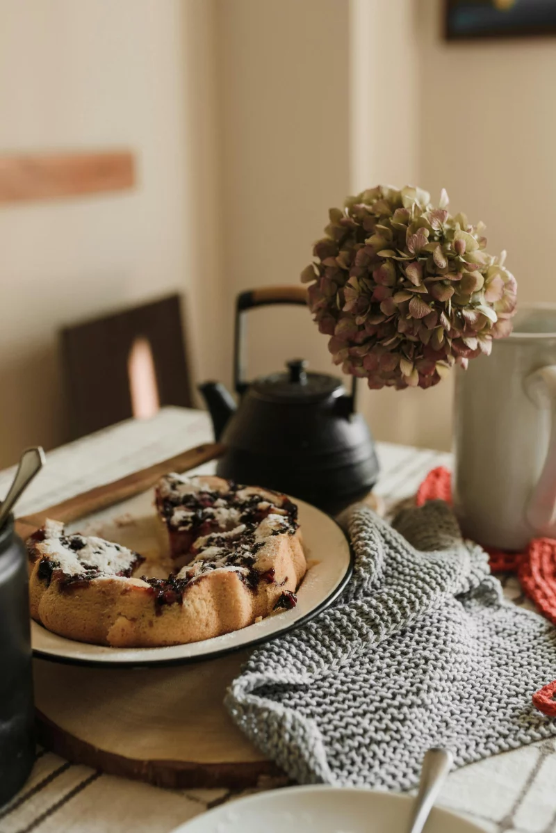 Warm, inviting scene of homemade blueberry cake and tea, perfect for an autumn afternoon.