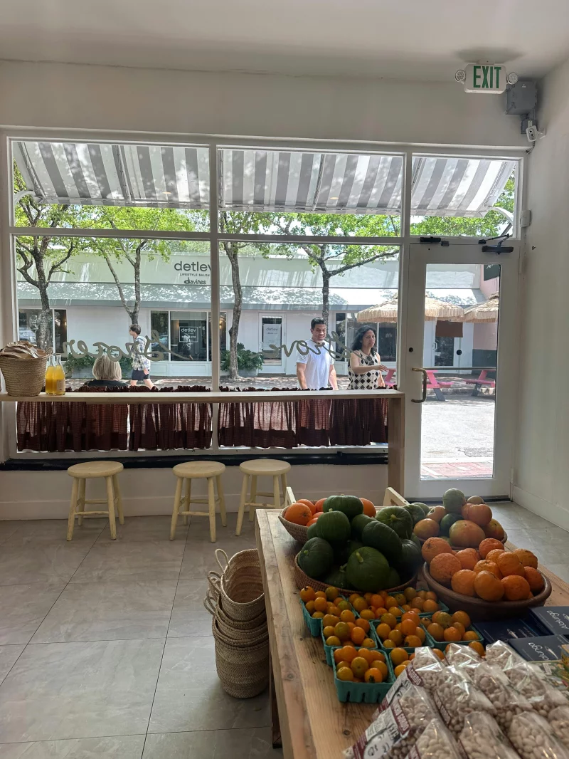Bright market scene with fresh produce inside a trendy store.