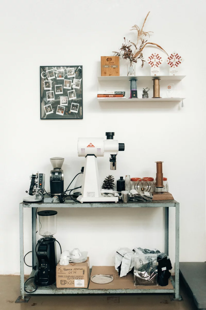 Minimalist kitchen shelf with coffee grinders and decor, perfect for any modern home.