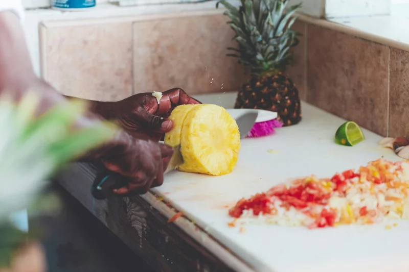 A chef prepares tropical fruits and vegetables indoors in Nassau, The Bahamas.