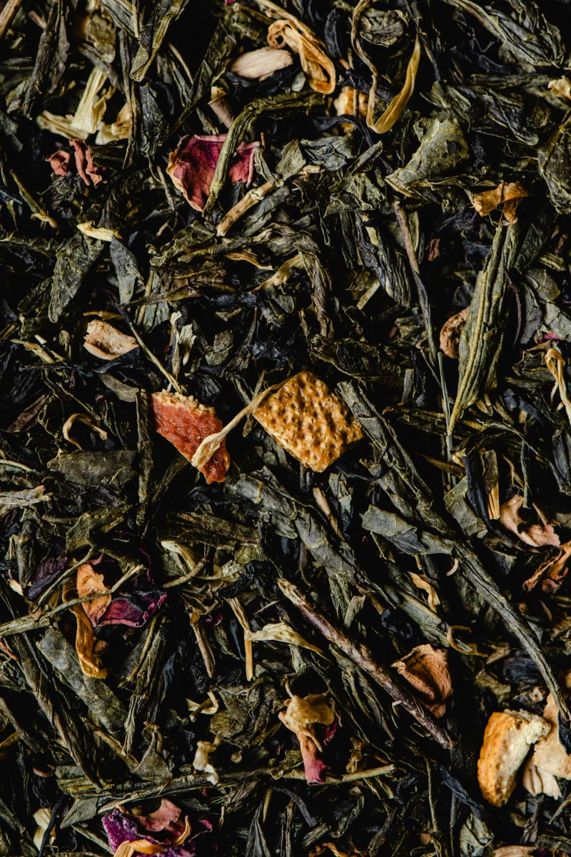 Detailed close-up of a diverse organic loose leaf tea blend with spices and dried fruit.