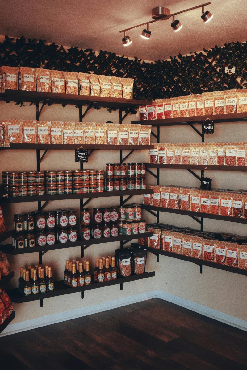 Neatly organized pantry showcasing various food items on shelves with warm lighting.