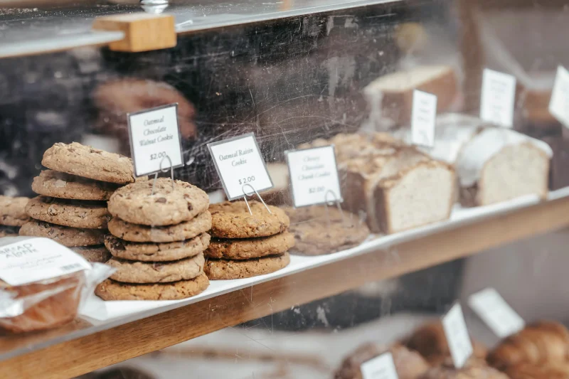 Freshly baked cookies and bread showcased in a local bakery display case.