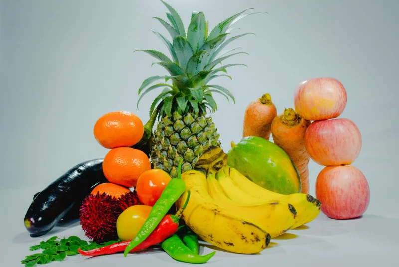 A colorful display of fresh tropical fruits and vegetables for healthy eating.