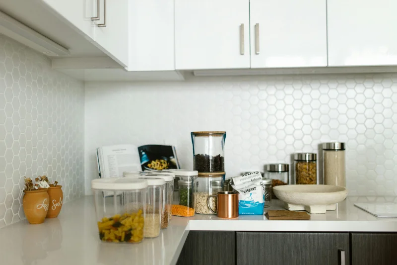 Elegant kitchen with organized containers and ingredients, creating a neat cooking space.