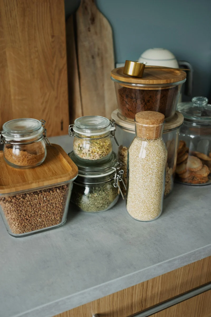 Elegant kitchen setup with glass jars and wooden accents, perfect for a modern pantry.