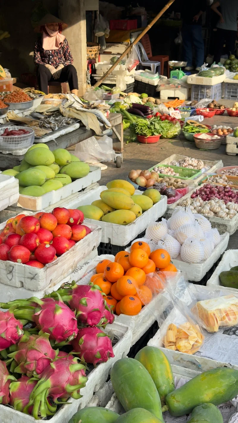 Colorful display of fruits and vegetables at an outdoor market, showcasing diversity and freshness.