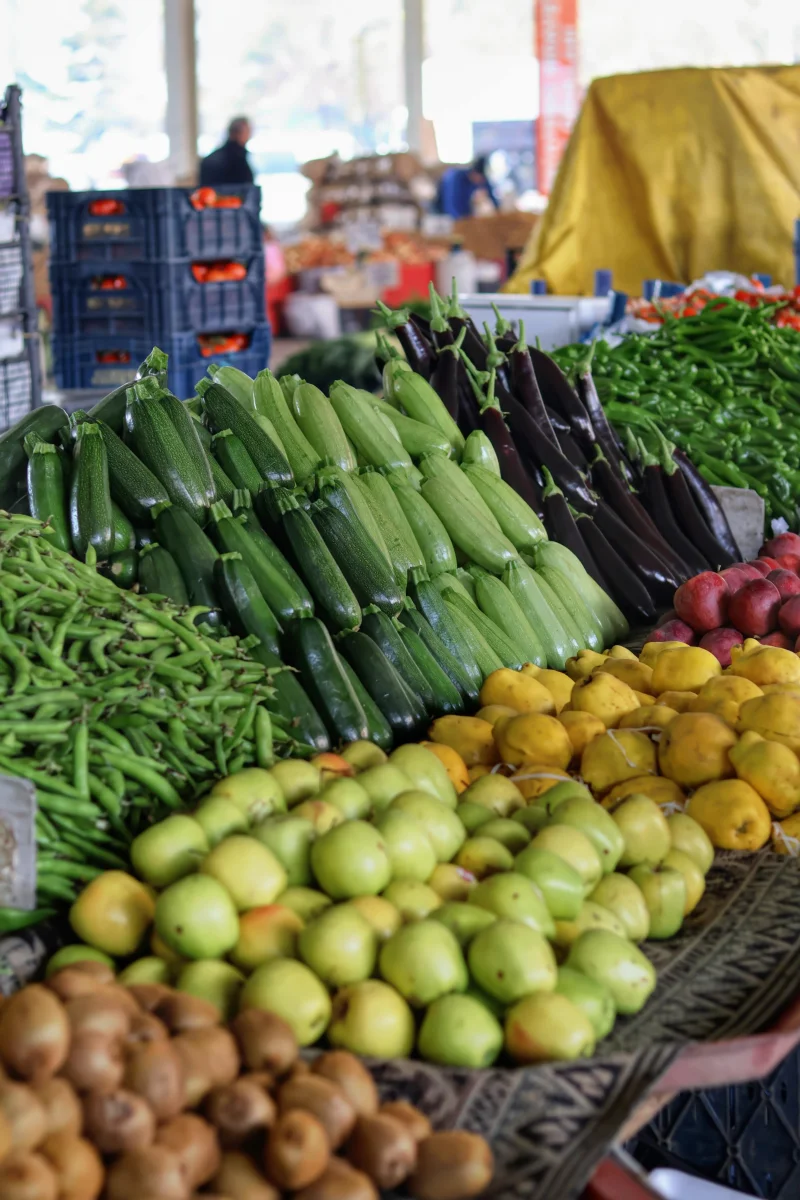 Vibrant display of fresh fruits and vegetables at an outdoor farmers market.