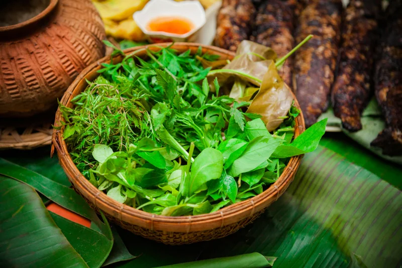 Vibrant fresh herbs in a traditional basket, capturing the essence of Vietnamese cuisine.