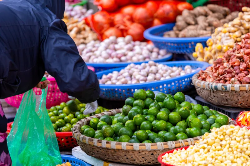 Bright and colorful display of fresh produce at a bustling Hanoi street market.