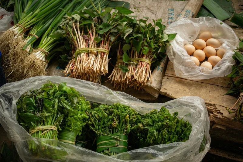 Colorful fresh produce and eggs at a local market in Yunnan, China.