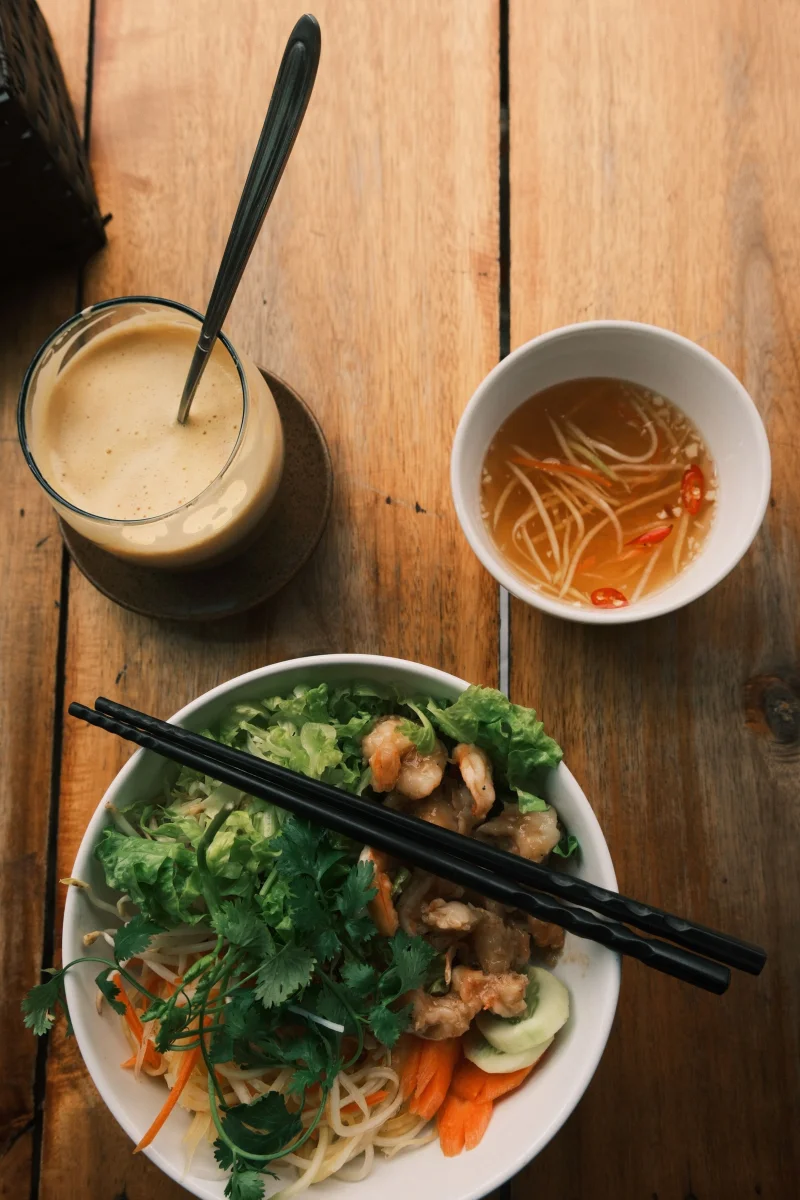 Traditional Vietnamese meal featuring fresh ingredients and classic flavors on a rustic table.
