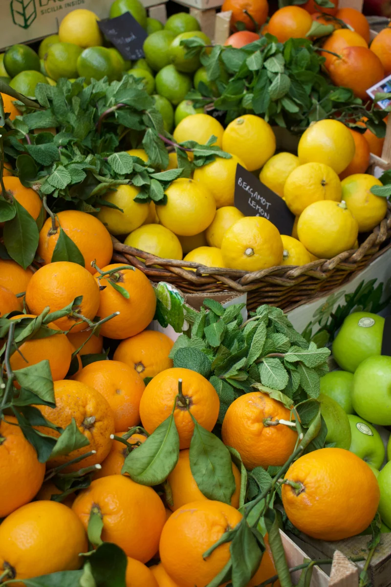 Vibrant citrus fruits including oranges, lemons, and limes on display at a market.