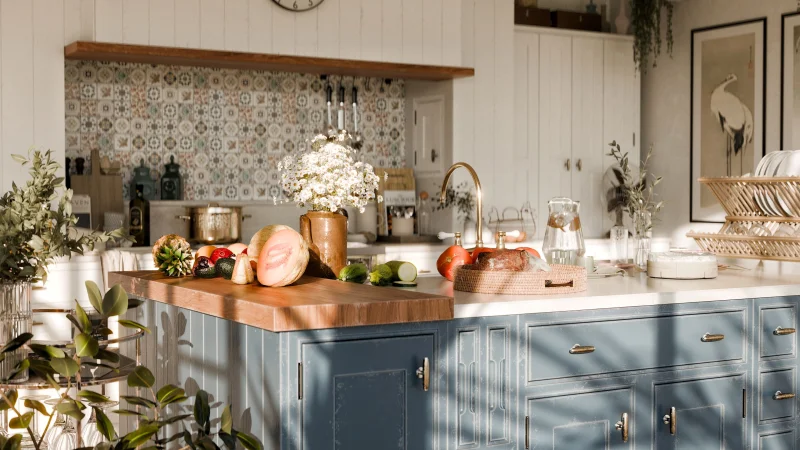 Charming kitchen design featuring fresh fruits and vegetables on a wooden counter with stylish decor.