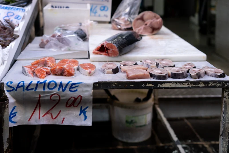 Sliced salmon displayed at a seafood stall in Naples market, Italy at €12 per kilo.