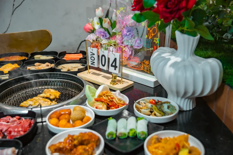 A vibrant table setting featuring diverse Asian BBQ dishes, perfect for celebrations.