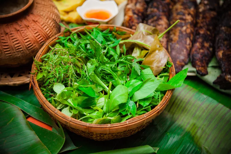 Vibrant fresh herbs in a traditional basket, capturing the essence of Vietnamese cuisine.