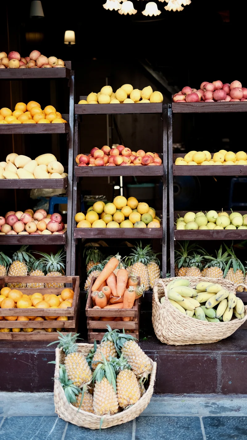 Colorful array of fresh fruits and vegetables at a Vietnamese market stall showcasing diverse produce.