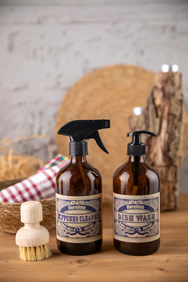 Vintage-style kitchen cleaner and dish wash set with natural brush on wooden counter.